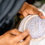 Lucknow artisan creating intricate Chikankari embroidery by hand on fabric using traditional stitching techniques.