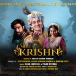 Promotional poster for Mere Krishn, a grand live theatrical performance featuring artists Sourabh Raaj Jain, Pooja Sharma, and Arpit Ranka, portrayed in mythological costumes against a dramatic blue and battlefield-inspired backdrop, with golden title typography and production credits.